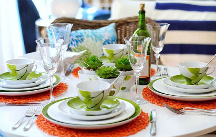 A layered colour table setting in green and white accents