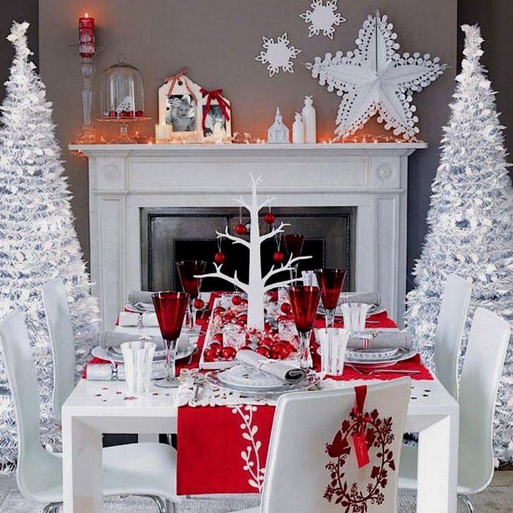 A stylish red and white Christmas table adorned with a white tree and red baubles