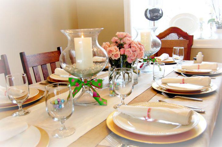 Adorable dining table setting with candle and floral centerpieces