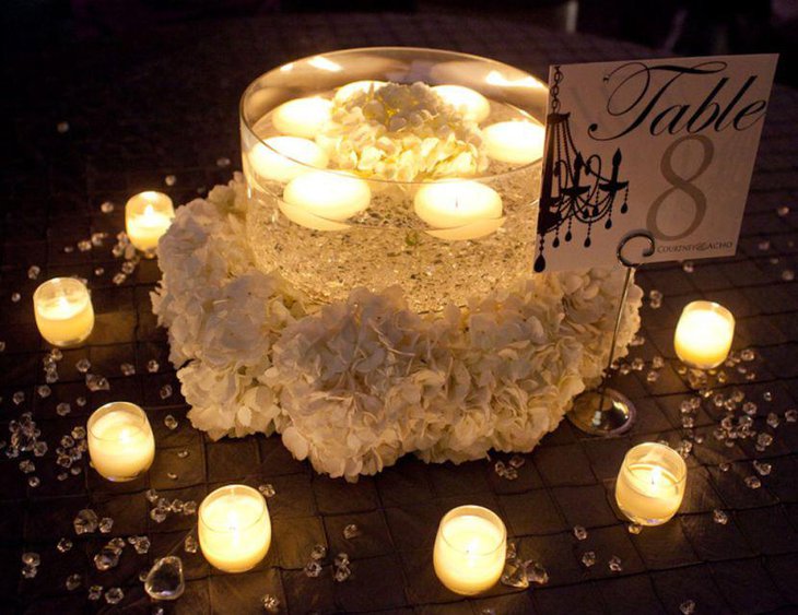 Alluring wedding tablescape with glass candle jar and votives