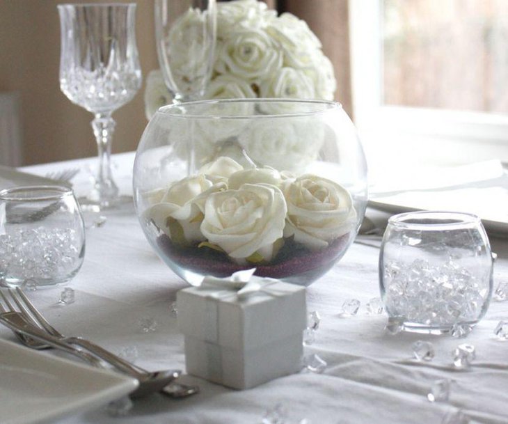 Amazing fishbowl with white roses as dining table centerpiece