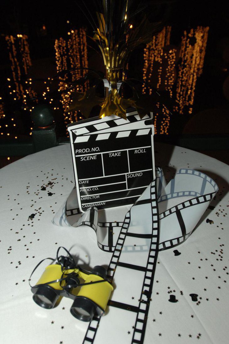 An oversized clapboard is placed on a party table as a main centerpiece