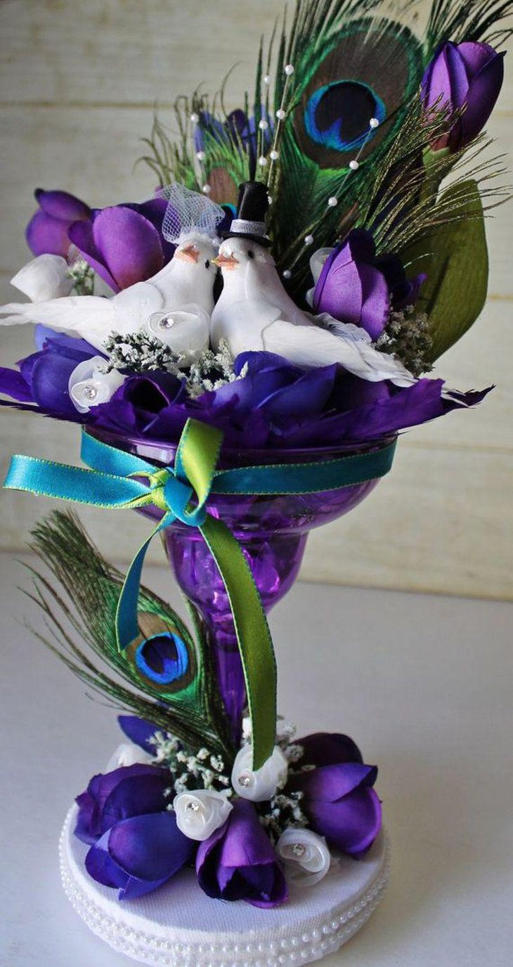 Appealing peacock themed purple wedding table centerpiece