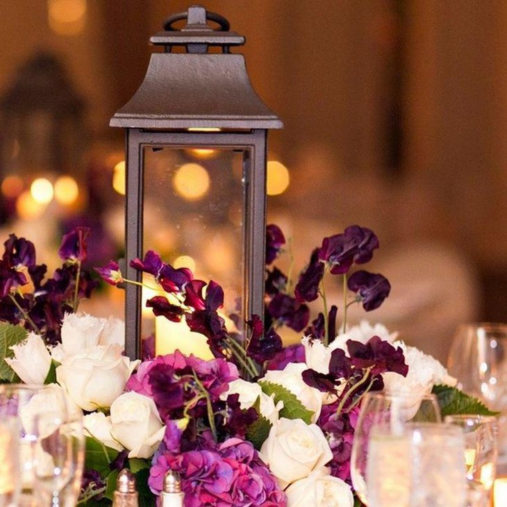 Appealing purple flowers and lantern decor for wedding table
