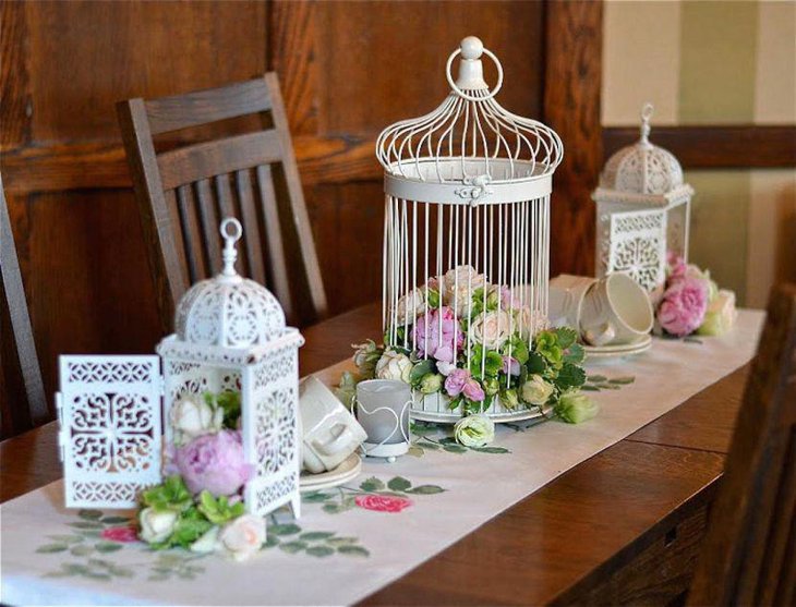 Appealing white iron birdcage centerpiece with flowers