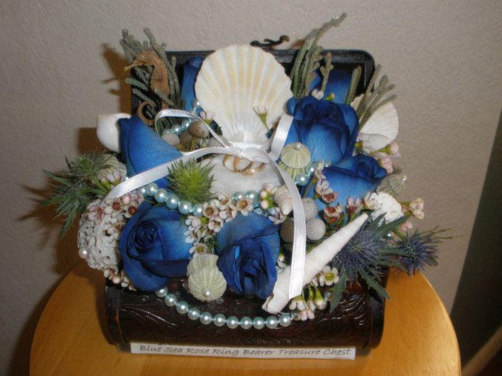 Aqua and white treasure chest wedding centerpiece with beach theme