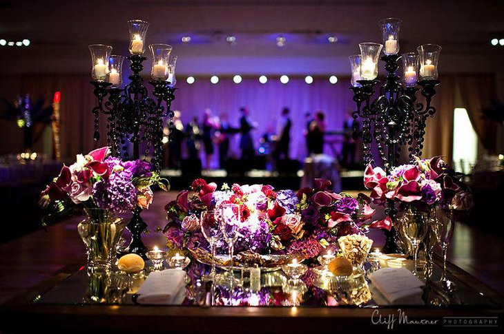 Astonishing purple wedding table decor with flowers and candle stands