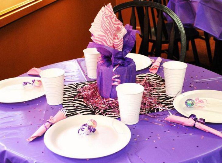 Attractive purple gift table centerpiece for girl baby shower