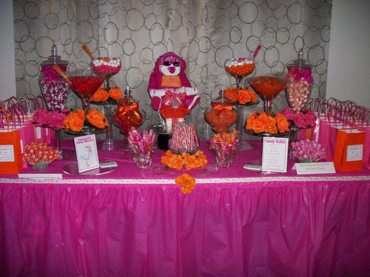 Awesome pink themed baby shower candy tablescape with pink favor bags toy and candies