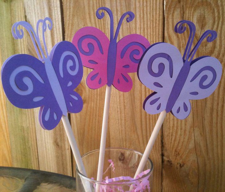Awesome purple and pink butterfly straw centerpiece on baby shower table
