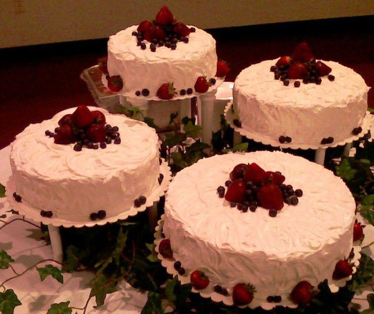 Awesome retirement table decor with white cakes topped with strawberries