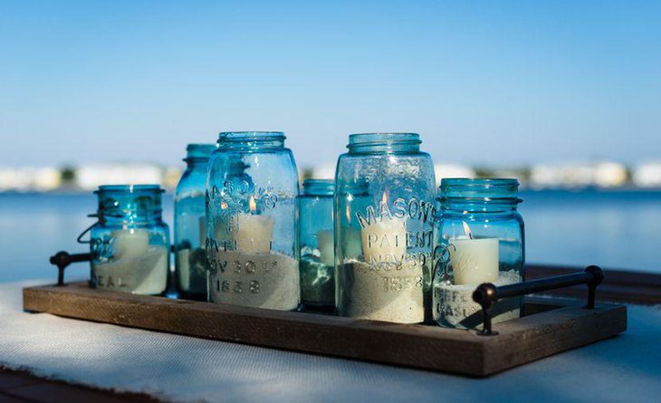 Beach themed candle and mason jar wedding table decoration