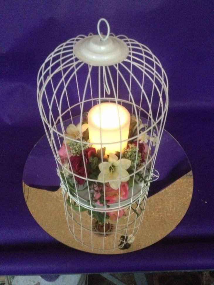 Beautiful birdcage centerpiece with candle and flowers