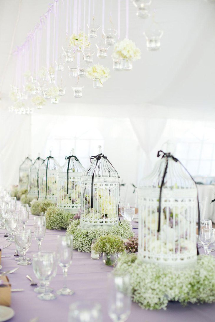 Beautiful birdcage centerpieces with greens and flowers