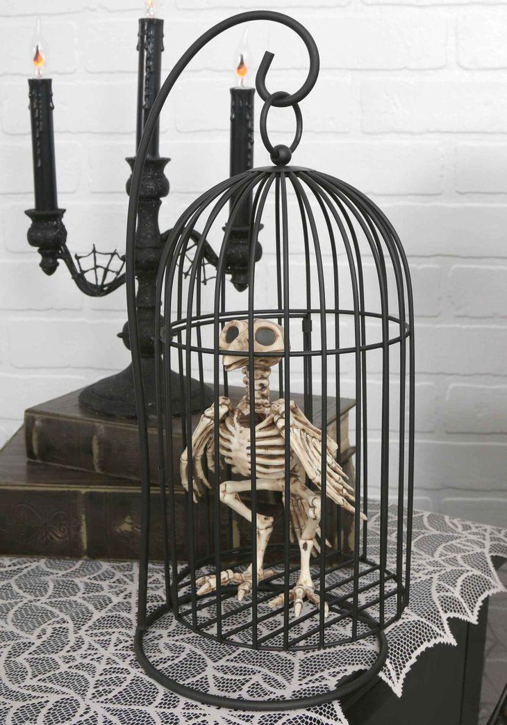 Beautiful black cage with skeleton bird as Halloween centerpiece