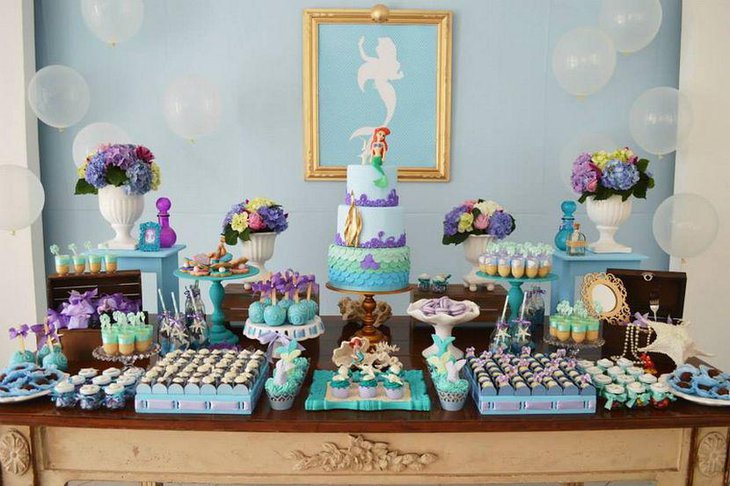 Beautiful mermaid baby shower table decor with floral accents