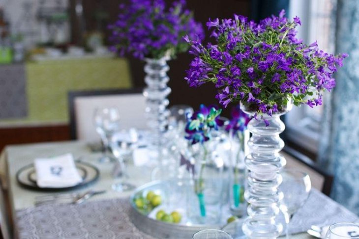 Beautiful purple floral decor on adult birthday party table