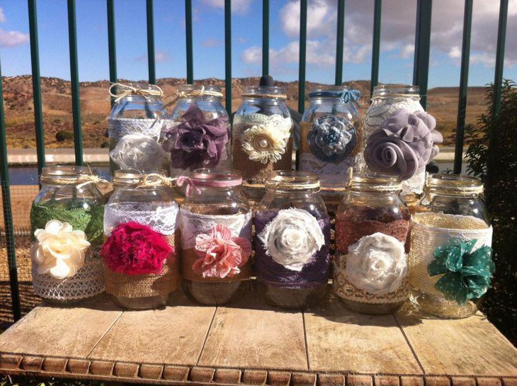 Beautiful Rustic Bottle Wedding Centerpieces Wrapped In Burlap Lace and Flowers