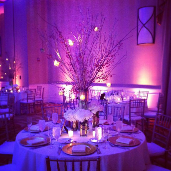 Beautiful spray painted branches with light bulbs as party table centerpiece