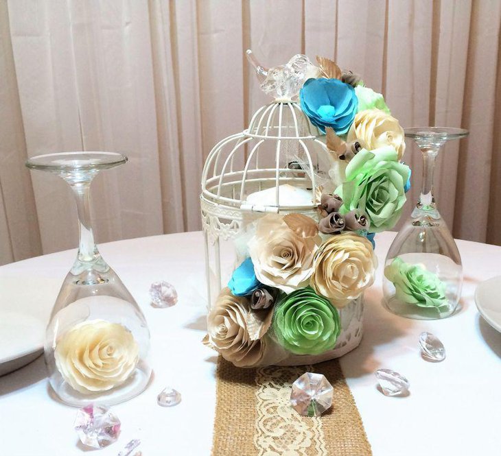 Birdcage centerpiece with paper flowers and candle