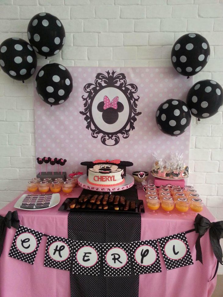 Black and pink themed Minnie Mouse candy buffet table decor