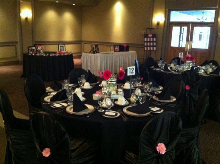 Black and white wedding reception decor with pink accents