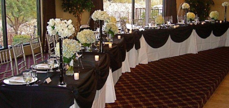 Black and white wedding reception decorations with black vases and flowers