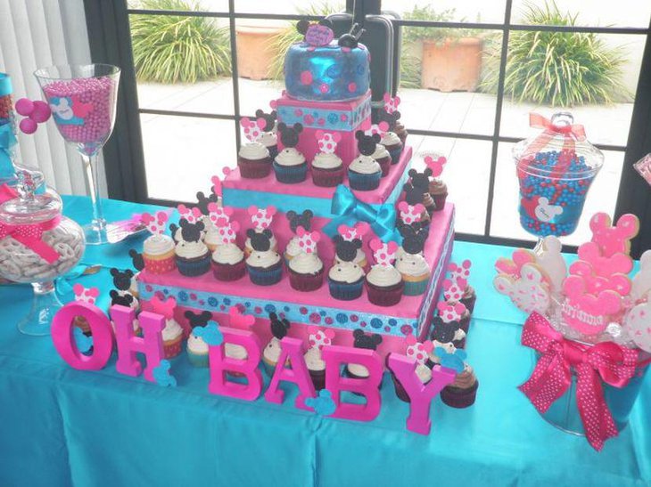 Blue and pink twin baby shower table decked up with Mickey and Minnie Mouse theme