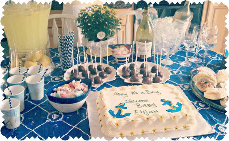 Blue and white anchor cake centerpiece on nautical themed baby shower table