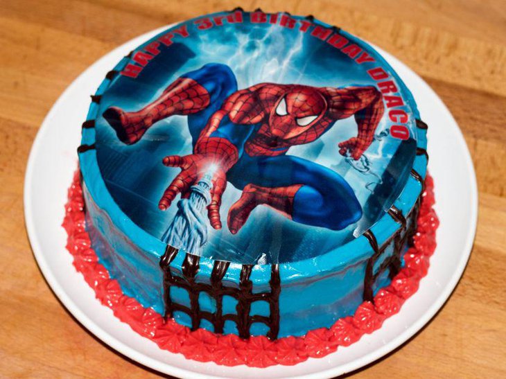 Blue birthday cake with spiderman image