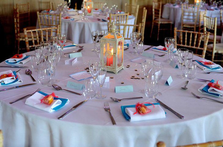 Blue red and orange decor on wedding breakfast table