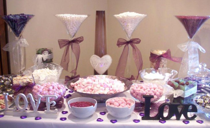Charming wedding candy bar table with purple tones