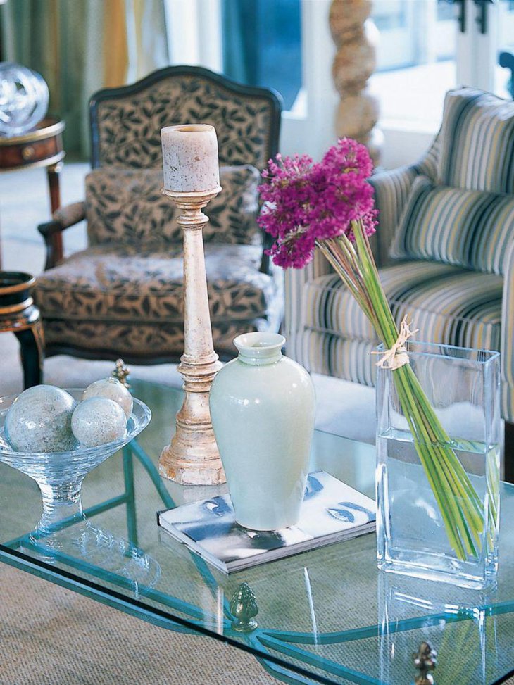 Chic contemporary coffee table setting with candlestick and flowers