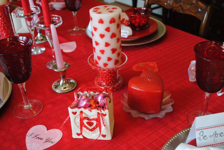Chic red heart candle and tablecloth decor on Valentines table