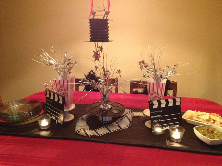 Clapboard and movie print reel displayed as party table centerpieces