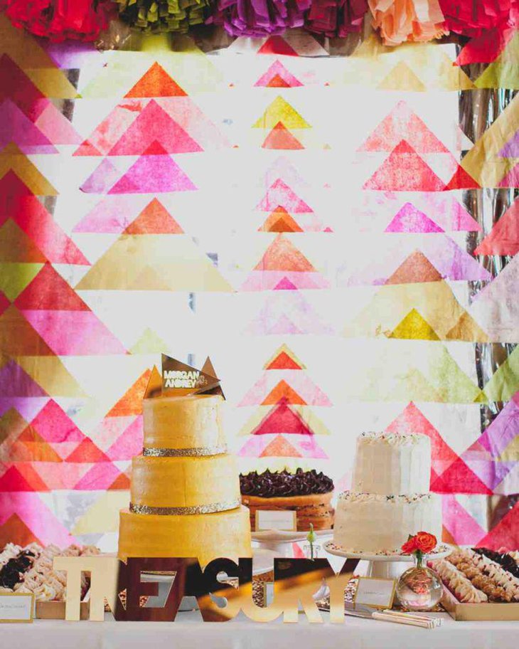 Colourful backdrop decor for wedding cake table