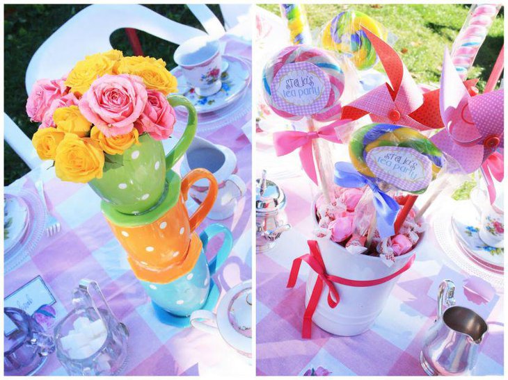 Colourful tea party tea cup centerpiece with flowers and bucket filled with lollipops