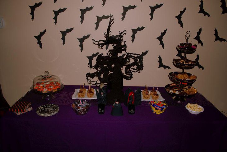 Cool Halloween dessert tabletop decor with black tree centerpiece and treats