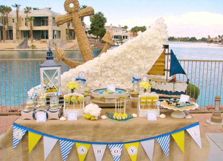 Creative nautical baby shower table setting with sailboat centerpiece