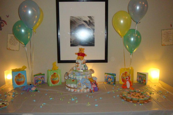 Creative Winnie The Pooh baby shower table decor with cute diaper cake centerpiece