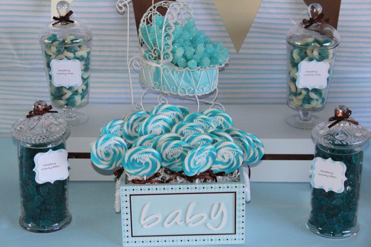 Cute blue baby shower candy table with whirly pops in blue accents
