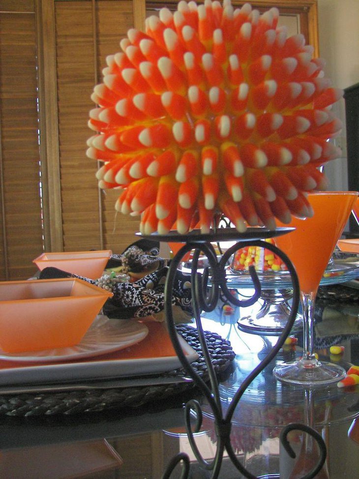 Cute candy cane ball on candleholder as Halloween table centerpiece