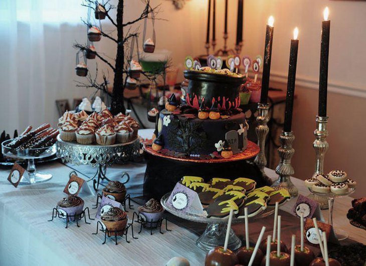 Cute Halloween Table Decoration With Black Candles and Yummy Deserts