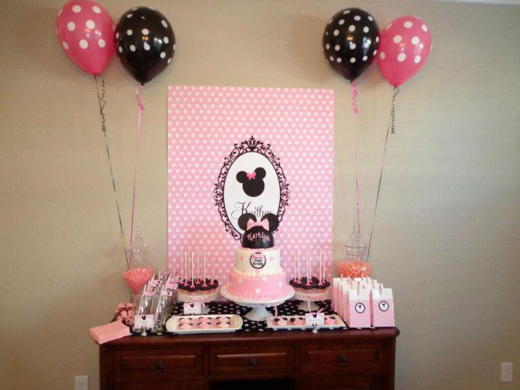 Cute Minnie Mouse candy table decor with pink and black accents