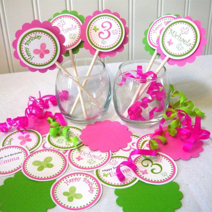 Cute pink and white DIY party table decor with glass jars wooden sticks with paper cut outs and ribbons