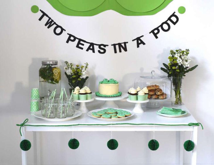Cute two peas in a pod themed baby shower table in green accents