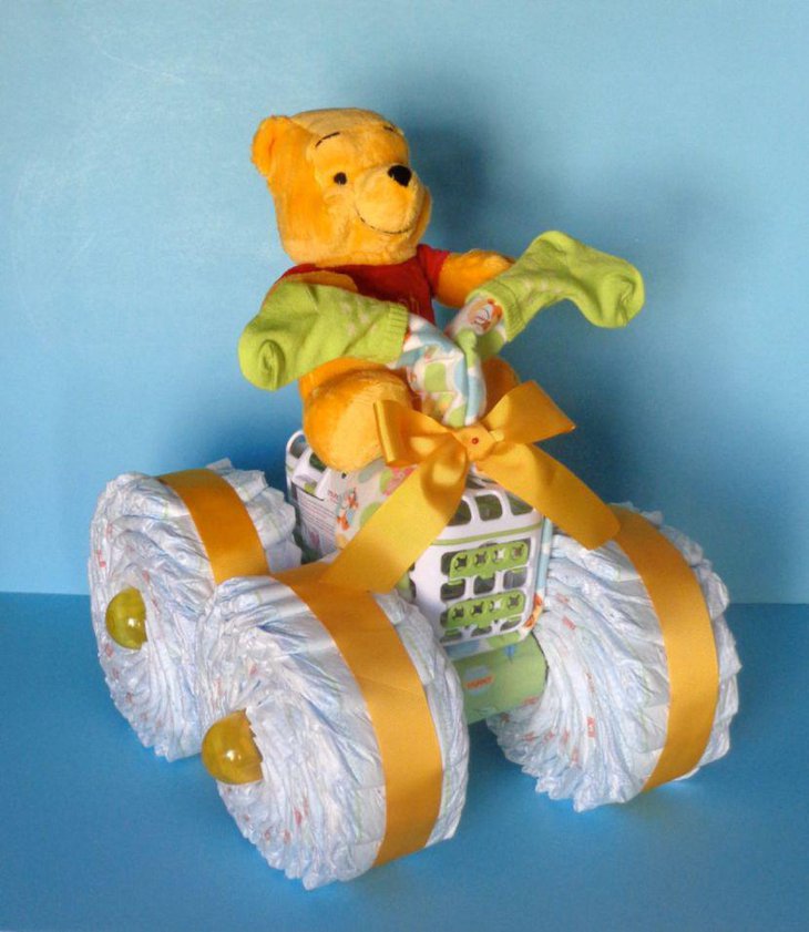 Cute Winnie The Pooh diaper cake centerpiece for baby shower
