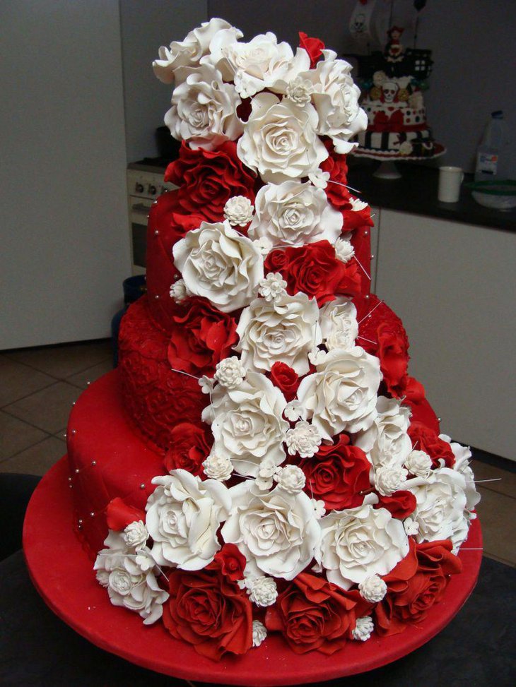 Delectable red wedding cake decorated with red and white flowers