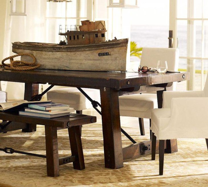 Dining table setting with rustic looking wooden boat centerpiece