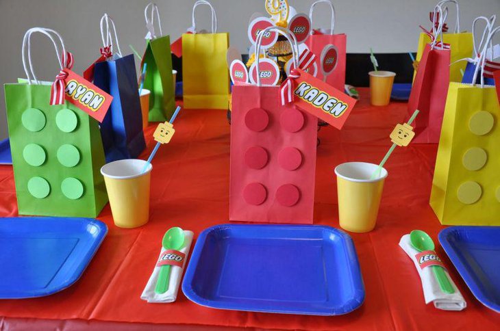 DIY Lego themed table decor with colourful paper bags and Lego head staws